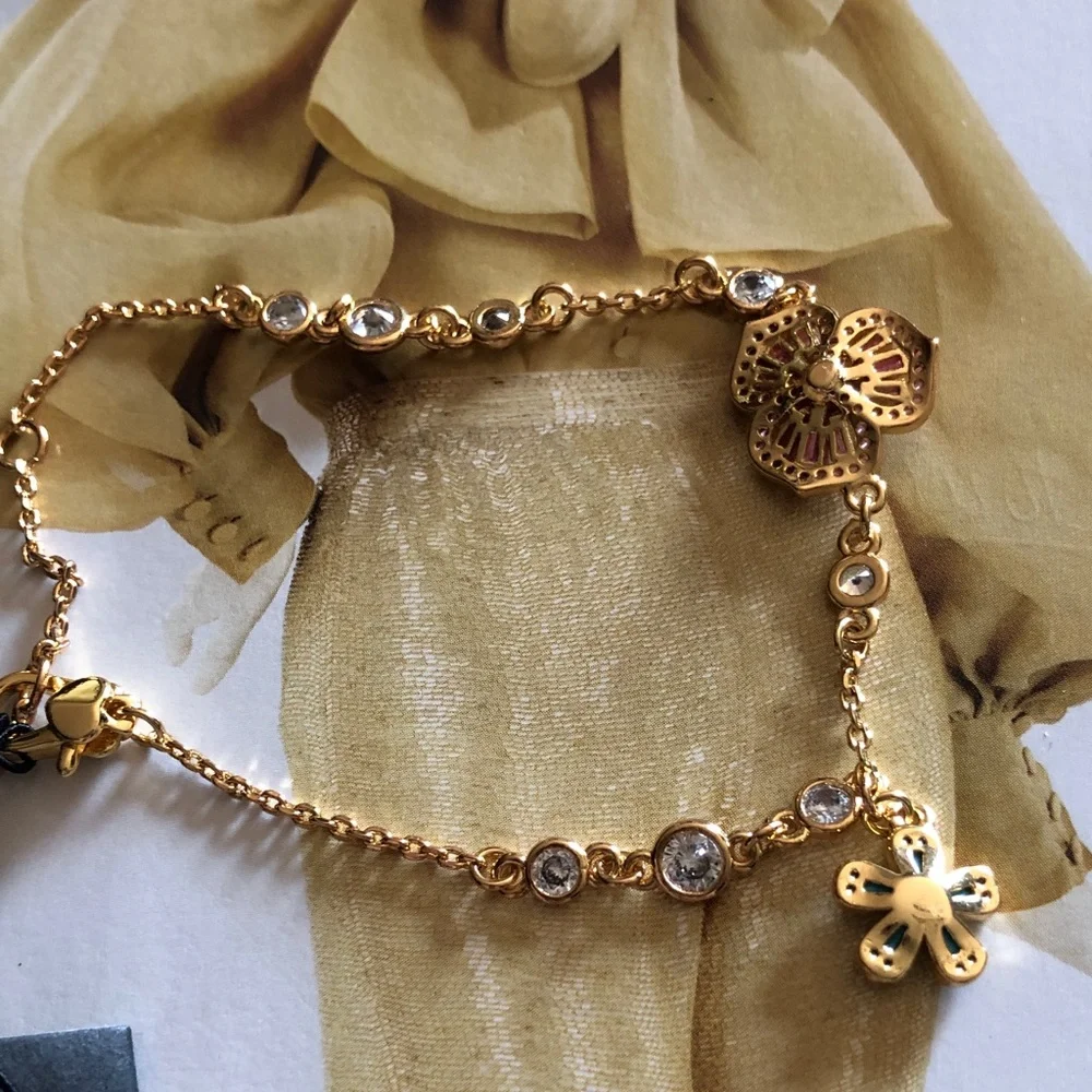 Authentic New with tag. kate spade Gold Bracelet with flower crystals.